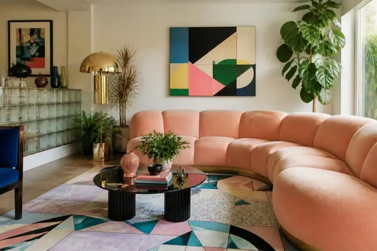 Modern living room with 80s maximalist style: peach curved sofa, pastel rug and bold geometric art